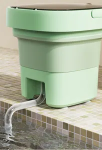 Portable folding mini washing machine detail shot, light green compact design with drain hose.