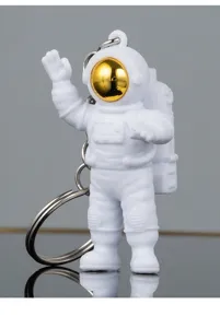 White astronaut keychain with golden reflective helmet visor, metal ring, ideal gift.