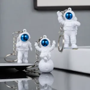 Cute astronaut keychain set with blue visor, perfect novelty gift and bag charm.