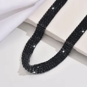 Detailed close-up view showing the stunning black multi-row rhinestone claw chain necklace.