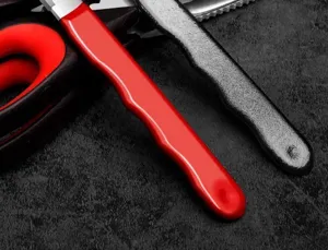 Close-up detail of ergonomic garden shear handle with durable red and black finish design.
