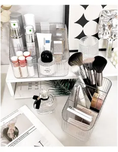 Clear desktop makeup organizer for cosmetics, brushes, and skincare products detail view.