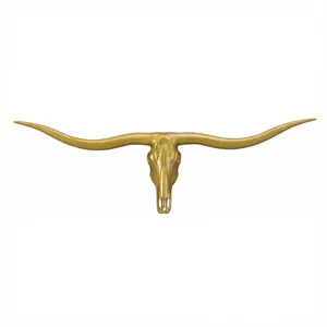 detailed close up of retro gold longhorn bull skull wall hanging for industrial decor
