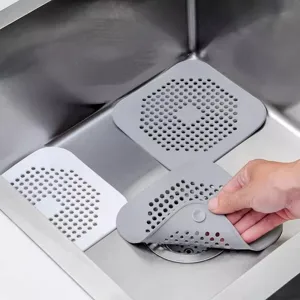 Silicone sink strainer hair catcher drain cover for kitchen and bathroom use, grey and white.