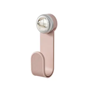 Pink rotating wall-mounted hook kitchen storage rack punch-free versatile household organizer.