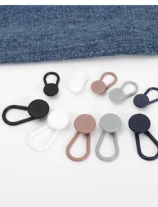 Close-up of adjustable button extenders for jeans waistbands in assorted colors and sizes.