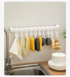 Support suspendu de cuisine avec plusieurs clips pour ranger proprement chiffons et éponges.