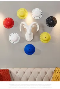 Nordic style sheep head wall hanging and colorful disc decor for living room background.