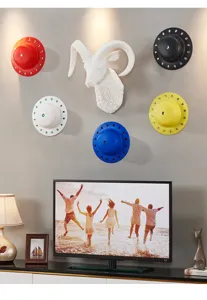 Nordic style animal head wall hanging and colorful disc decor for modern living room setup.
