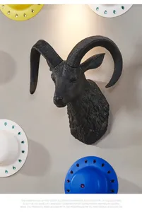 Detailed close-up of the black resin ram head wall hanging with curved horns for Nordic decor.