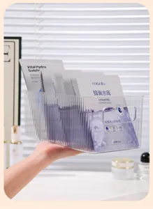 Detailed view of a clear ribbed acrylic mask organizer box holding beauty masks on a vanity