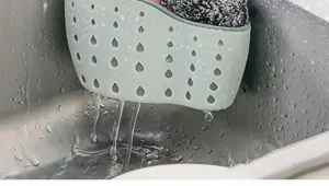 Silicone sink drain basket detail view, hanging sponge holder with water drainage holes.