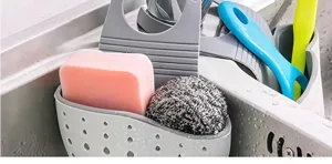 Silicone kitchen sink caddy hanging storage basket for sponge soap draining and organization.