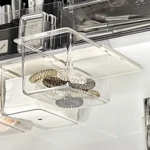 Clear acrylic under-cabinet drawer organizer for bathroom cotton pads and small items storage.