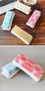 Household laundry cleaning brush with durable stiff bristles and ergonomic plastic base.