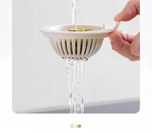 Kitchen sink strainer basket detail view, white plastic draining tool for food scraps.