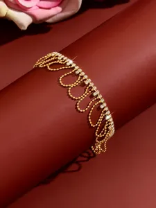 Gold rhinestone wave tassel anklet for women, sparkling summer beach foot jewelry piece.