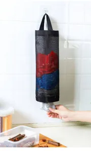 Kitchen wall-mounted mesh grocery bag holder detail shot, black hanging storage organizer for bags.