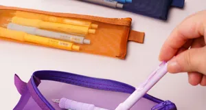 Transparent mesh pencil case detail, colorful zipper pouch, compact stationery storage bag.