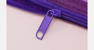 Close up detail of purple zipper and mesh fabric for pencil case stationery storage accessory.