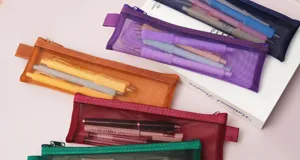 Detailed view of colorful transparent mesh pencil cases, lightweight stationery storage bags.