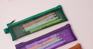Transparent mesh pencil case detail view showing colorful stationery bags with zip.