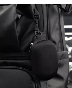 Portable black storage pouch with zipper and hook, ideal for backpacks and outdoor gear.