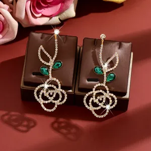 Sparkling rhinestone flower earrings with green crystal leaves, elegant high-end fashion jewelry.