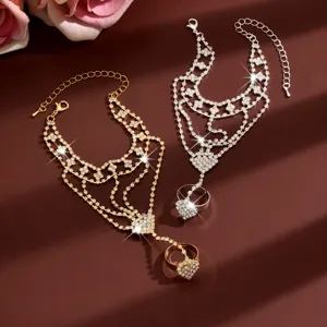 Close-up detail shot of sparkling rhinestone heart slave bracelets, elegant hand chain design.