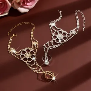 Close-up detail of rhinestone flower finger connected bracelet tassel back chain jewelry.