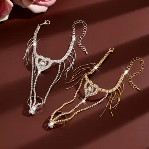 Detail view of sparkling rhinestone heart hand chain bracelet with elegant flowing tassels.