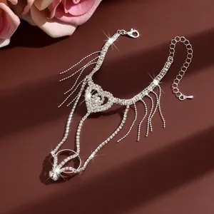 Stunning close-up detail of sparkling rhinestone hand chain featuring cute heart and fringe.