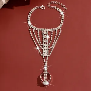 Detailed view of the sparkling rhinestone hand chain, featuring intricate layered tassel design.