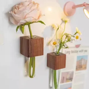 Close-up detail of the wooden test tube wall planter displaying fresh flowers in a cozy setup.