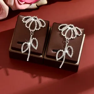 Sparkling rhinestone flower tassel earrings, elegant bow design for women, luxury party jewelry.