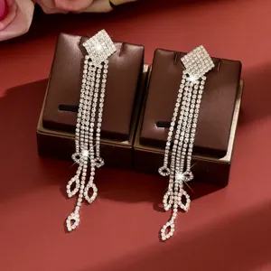 Sparkling rhinestone long tassel earrings featuring crystal diamonds and bow design for women.