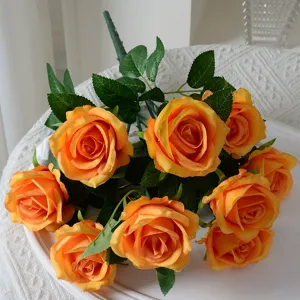 Beautiful bouquet of 9 orange artificial silk roses for elegant home and wedding table decor