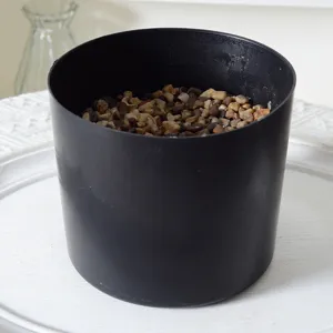 Black plastic flower pot designed specifically for artificial plants with pebbles inside.