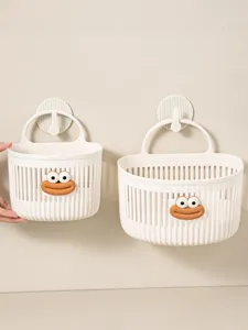 Close-up detail of white plastic hanging storage basket with cute cartoon face and hook.
