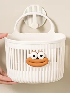 Close-up of the cute hanging storage basket with cartoon face for bathroom or kitchen.