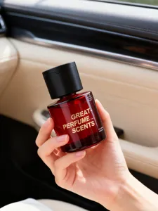 Macro view of 150ml red glass car perfume bottle held by hand in vehicle interior