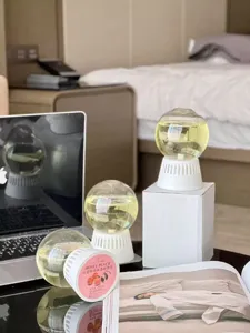 Detail view of the spherical room diffuser in a cozy bedroom setup, long-lasting scent.