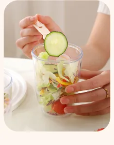 Portable plastic salad cup with fork, clear fruit container for outdoor picnic breakfast.