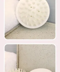 White silicone scalp massage brush and shampoo comb for relaxing head cleaning and hair care.