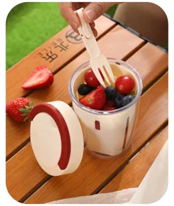 Portable double layer fruit salad cup detail, picnic container with fork and lid for fresh snacks.