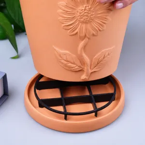 Flower pot elevated base detail showing durable terracotta design with ventilation grid stand.