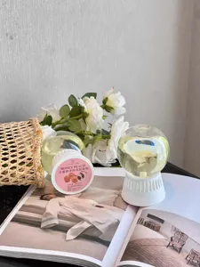 Detail shot of inverted aroma diffuser ball with peach scent, elegant home fragrance decor setup.