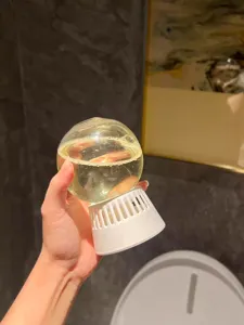 Close-up detail view of the inverted aroma diffuser glass ball with white ventilated base.