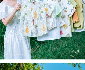 Outdoor travel clothesline detail showing shirts hanging on a portable rope in the green grass.