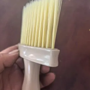 Window sill crevice cleaning brush with soft bristles and plastic handle for home dusting.